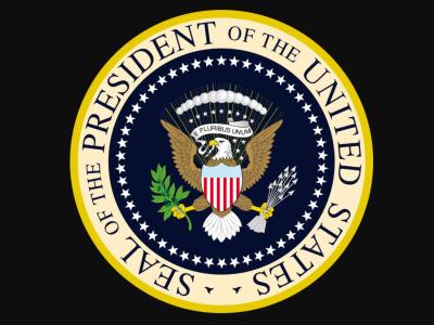Image of the seal of the President of the United States, as stated in a gold circle around the perimeter of a navy-colored circle depicting an eagle with a banner saying "E Pluribus Unum" in its mouth. Above its head & banner are 9 white stars & 13 white spheres. The eagle has a shield in front of its chest: it's blue at the top, red & white stripes on the bottom portion. The eagle holds an olive branch in its right talon, a bunch of arrows in its left talon. The navy color is encircled with white stars.