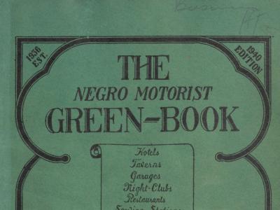 Image (cropped to the top half) of the cover of the 1940 Negro Motorist Green Book. The cover is medium green paper, printed in black ink. The book title and other text descriptions are edged by a rounded border.