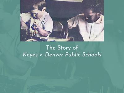 Photo of the cover of a book called "A Dream of Justice: The Story of Keyes v. Denver Public Schools." The cover is a blue color, with white text. In the center of the cover is a black and white image of two boys (one Black and one white) sitting next each other at school desks, drawing or writing. The author's name, Pat Pascoe, is in white text at the center-bottom of the cover.
