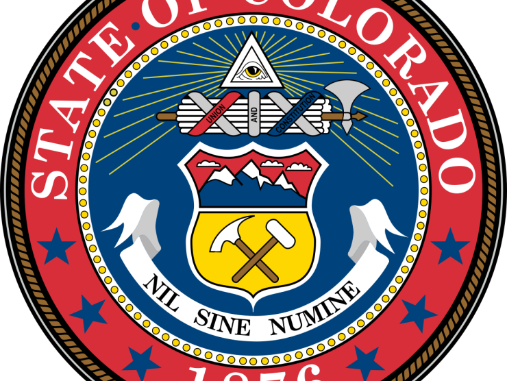 The state seal of Colorado, reading "State of Colorado, 1876: Nil Sine Numine."