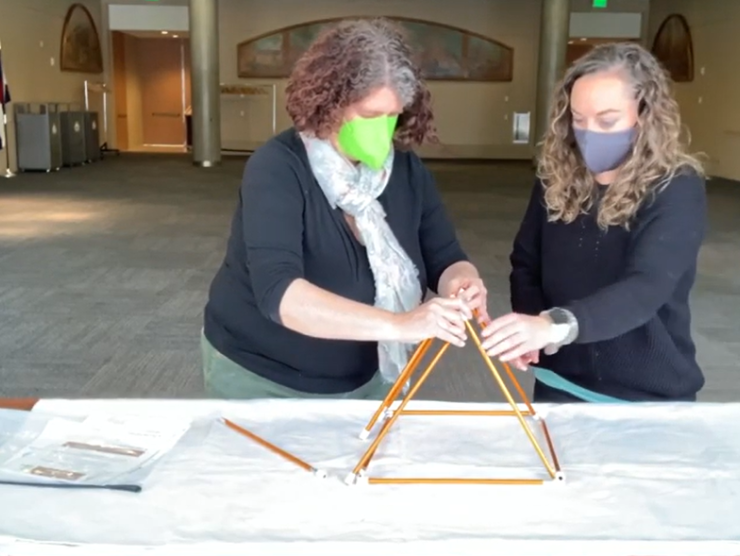 Two women demonstrating how to use Ute STEM equipment.