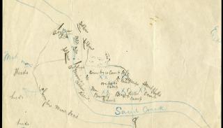 Image of a hand-drawn map on white paper. The map indicates North at the top of the page and South at the bottom; in thin cursive handwriting, the Sand Creek snakes its way from the left of the map, down to the south. There are "X" marks alongside the creek, with names that suggest who was positioned in the area. "Chivington Trail" is legible along a path leading from the south up north to the area where others were situated along the creek.