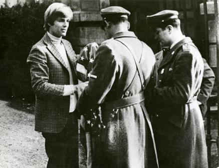 Dean Reed being arrested after protesting American foreign policy by washing an American flag outside the American Embassy in Santiago, Chile, 1970