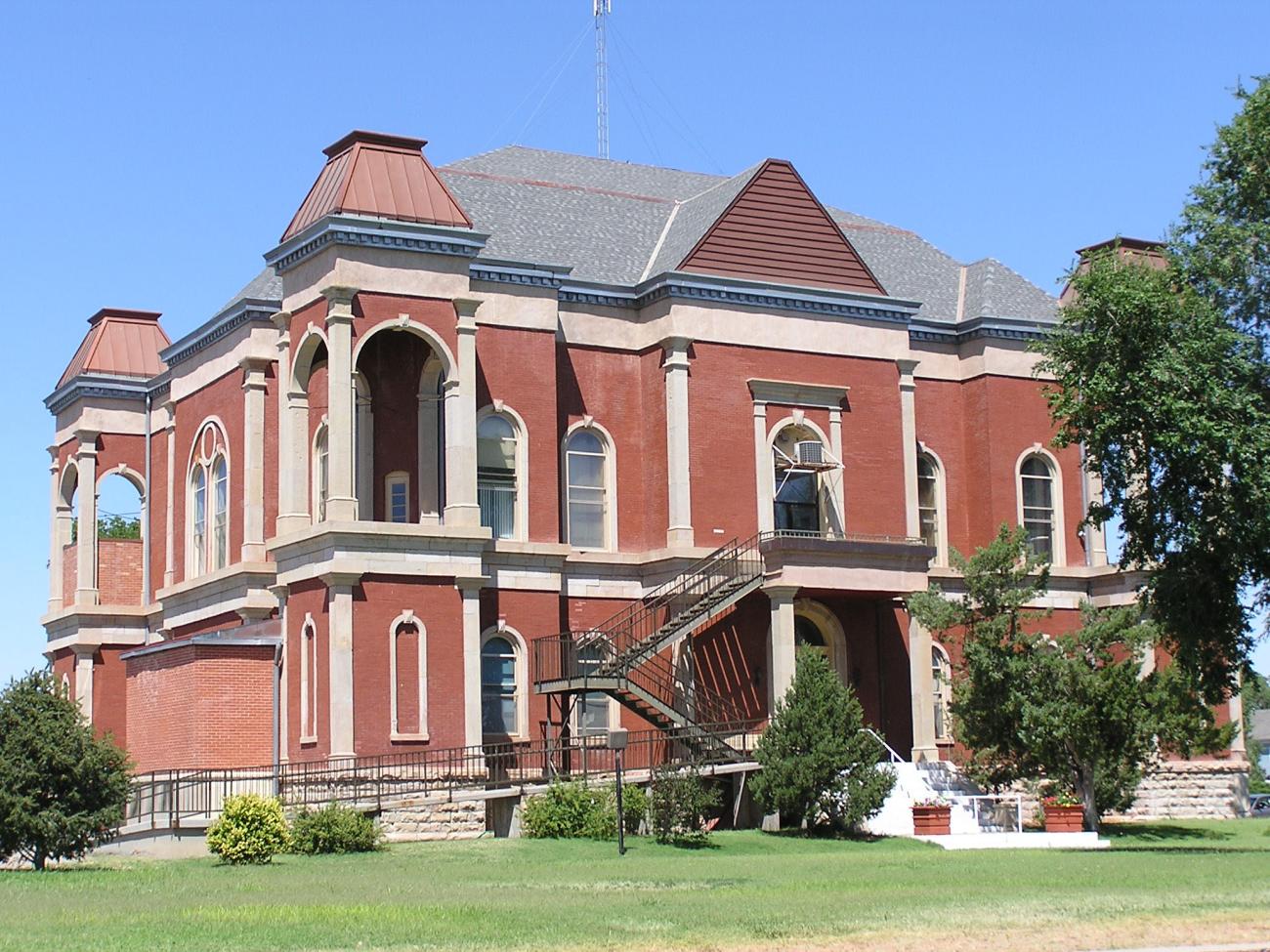 A photo of the Bent County Courthouse and Jail in Las Animas, a two story red brick building.