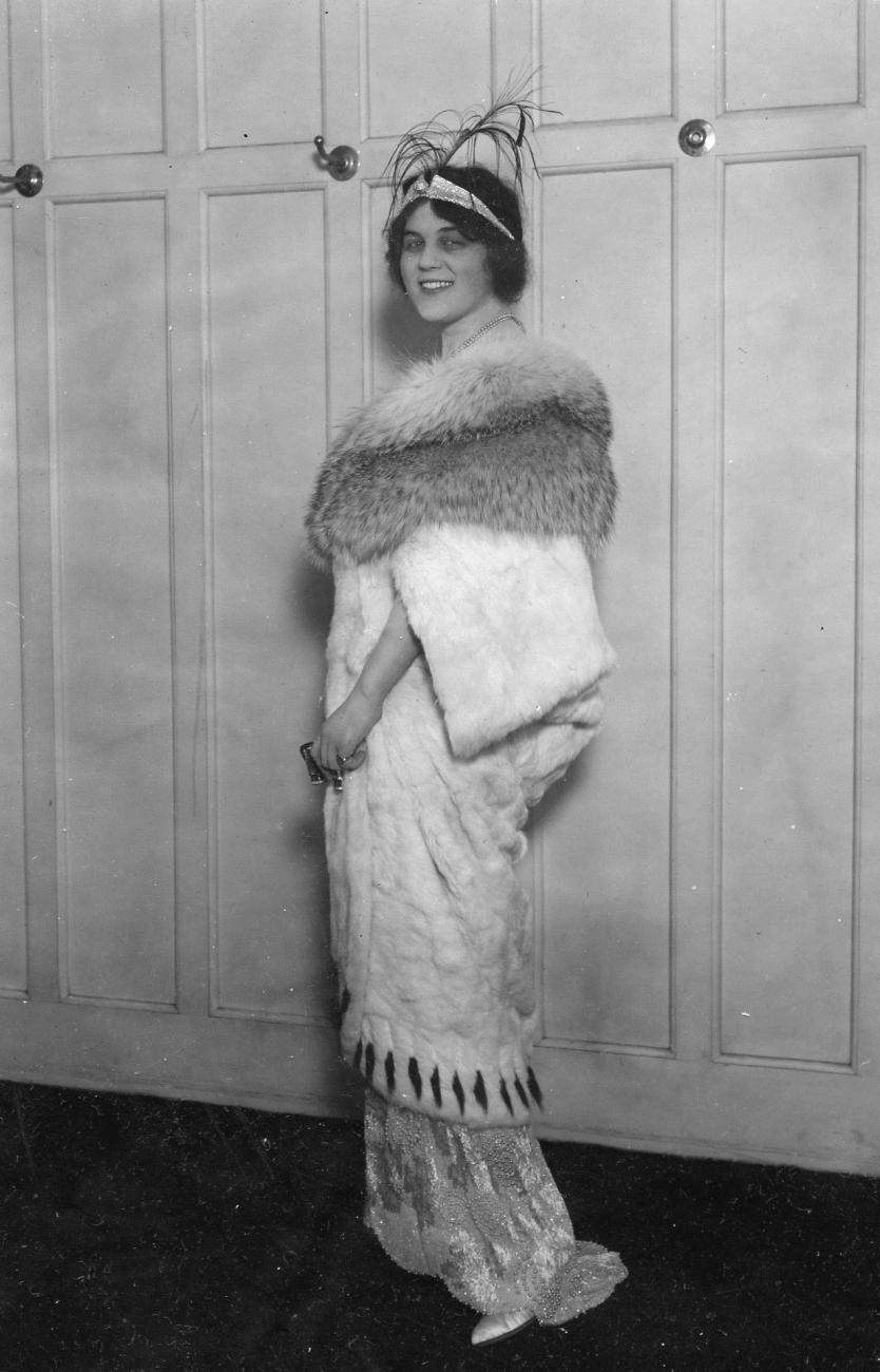 Model Margaret Gessing modeling an opera coat of ermine with white badger collar.