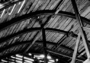 Black and white photo of the interior rafters in a Round-Roof Barn.