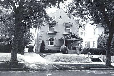 Black and white photograph of a Spanish Colonial Revival style house.