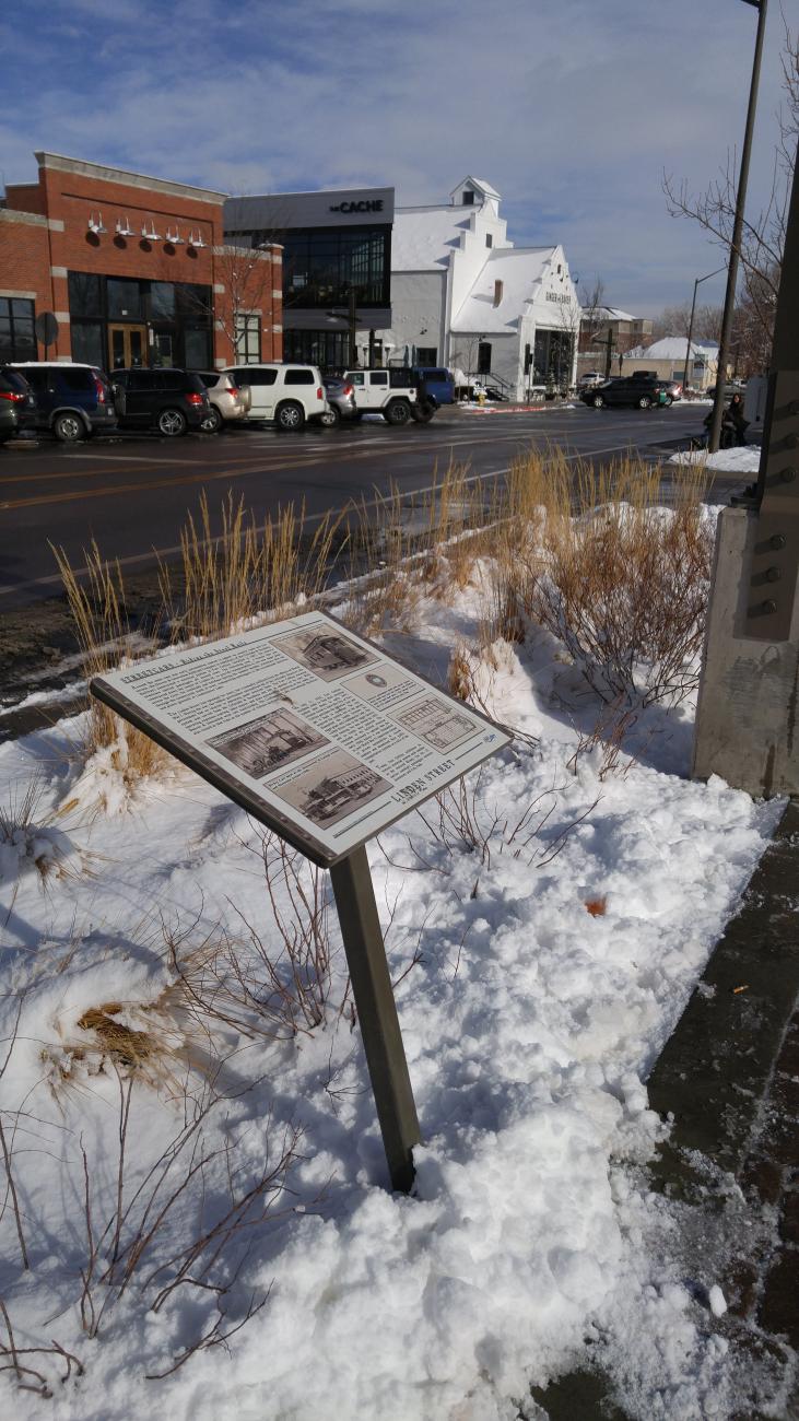 A sign describing historical context for new businesses in Fort Collins' Downtown River District.
