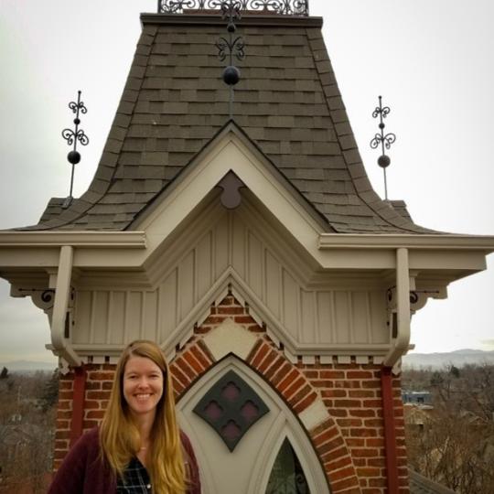 Photo of author Katie Arntzen, standing in front of an ornate building