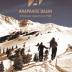 Image of the front cover a book titled "Arapahoe Basin: A Colorado Legend Since 1946." The authors, whose names appear at the bottom in small font, are Cathleen Norman and Alan J. Henceroth. The cover is a photograph of two skiers traversing a snow-covered hillside while looking at the snowy mountain in the distance. The sky is a brilliant blue, with no clouds in sight.